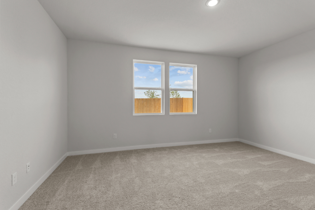 A room with a window and carpet.