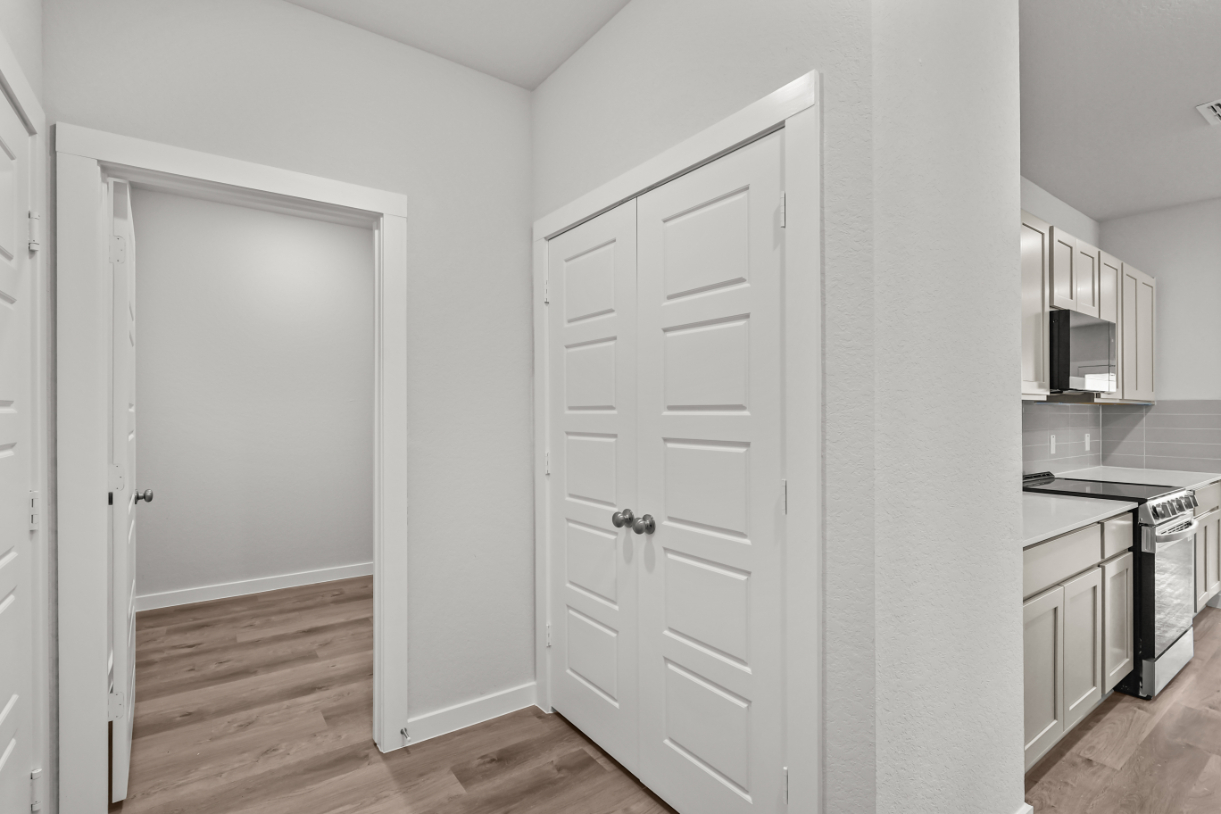 A kitchen with white cabinets.