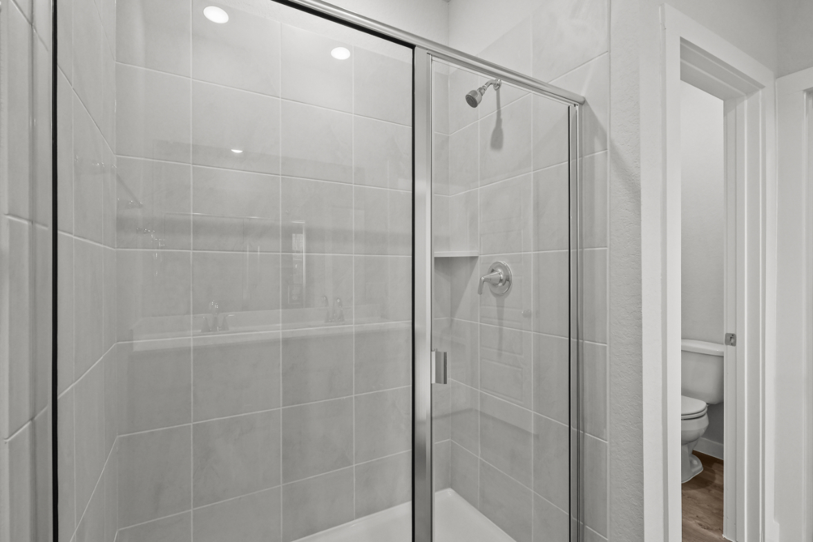 A shower with a glass door.