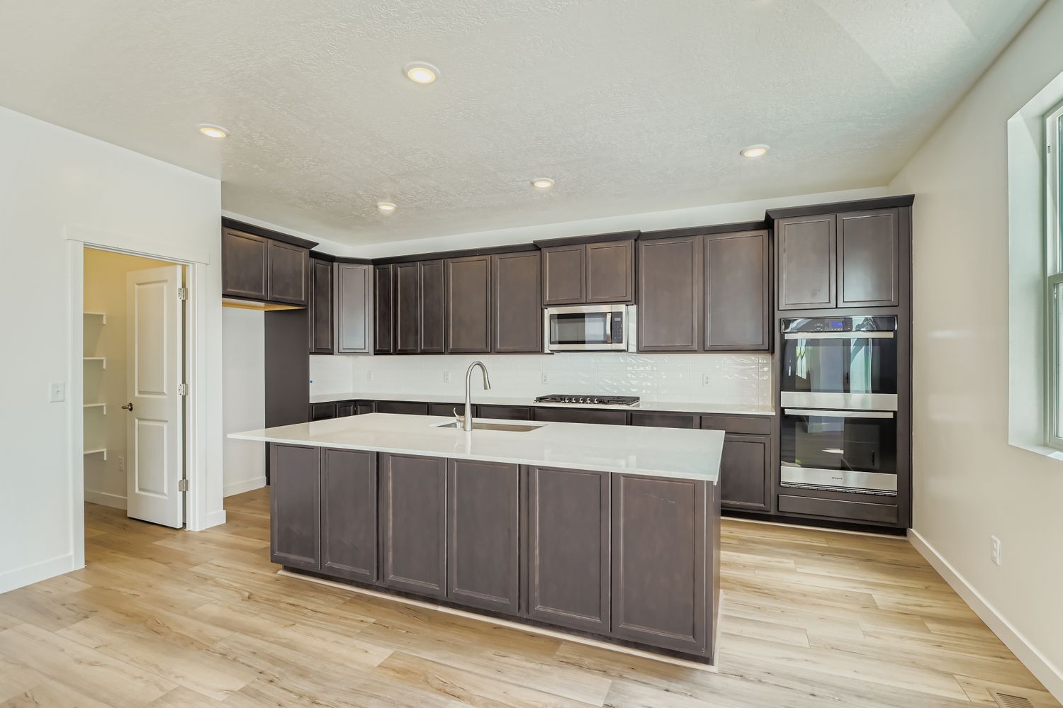 A kitchen with black cabinets.