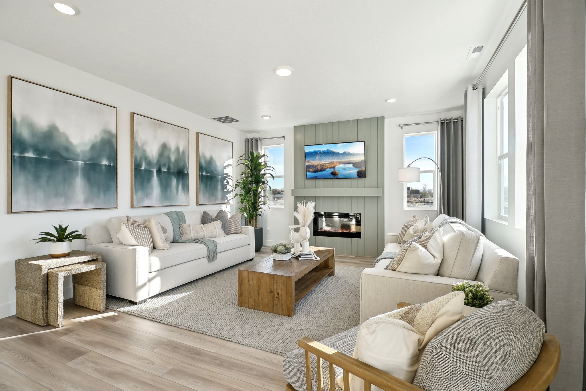 A living room with a large television.