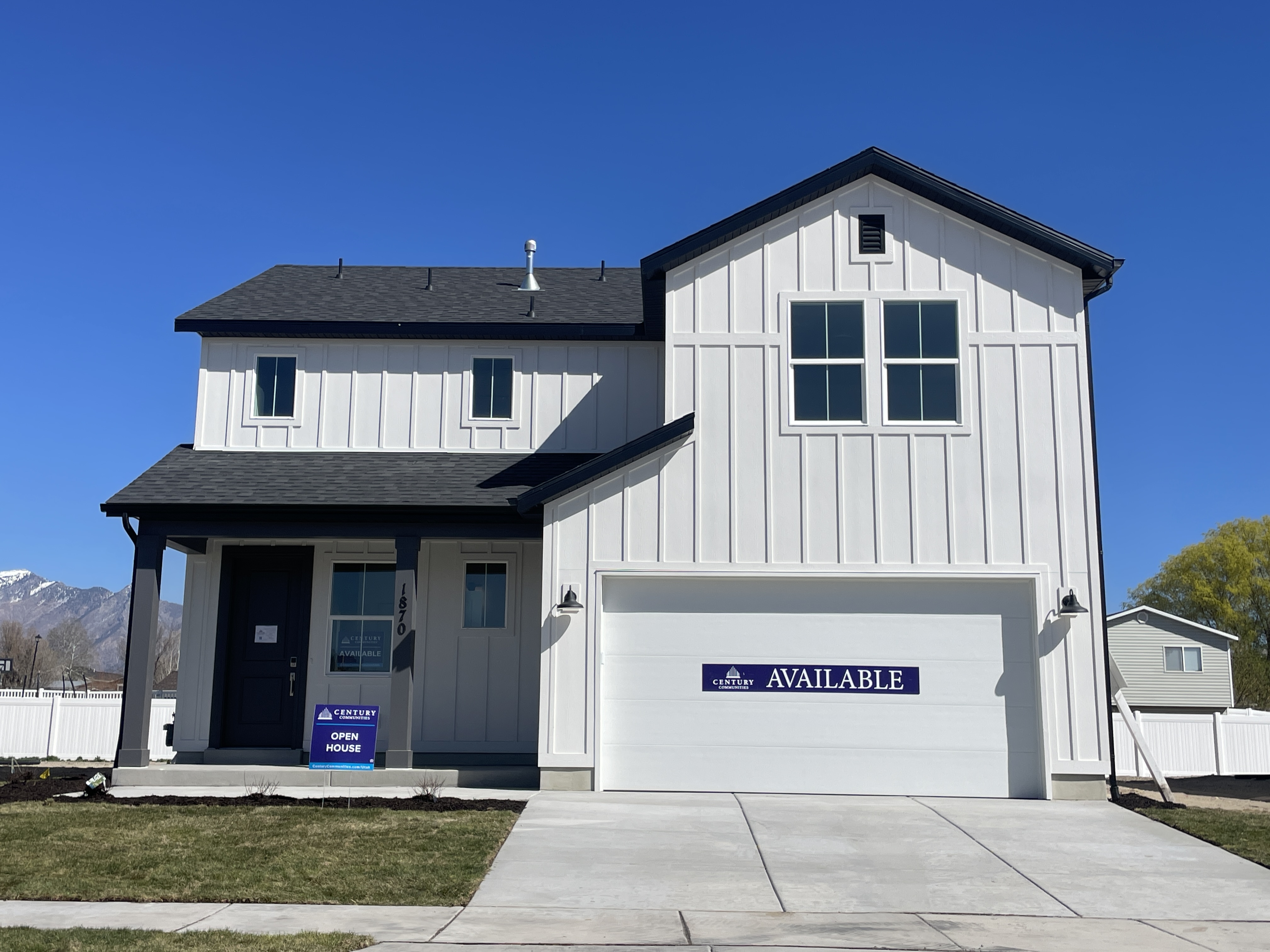 A white building with a black roof.