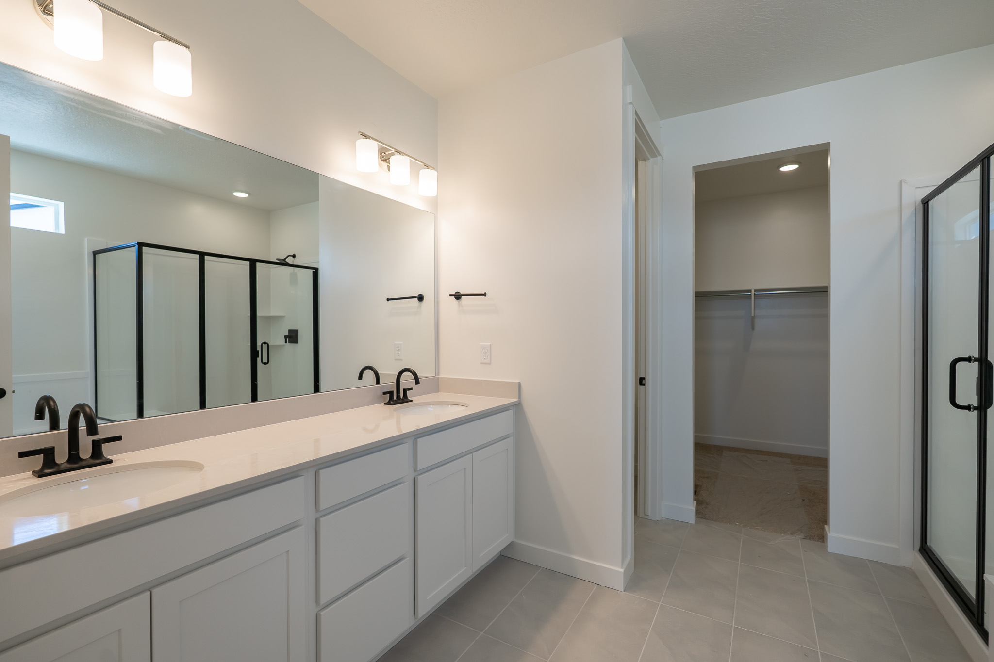 A bathroom with a large mirror.