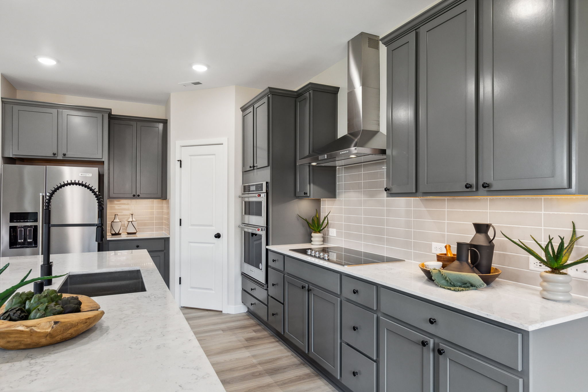 A kitchen with black cabinets.