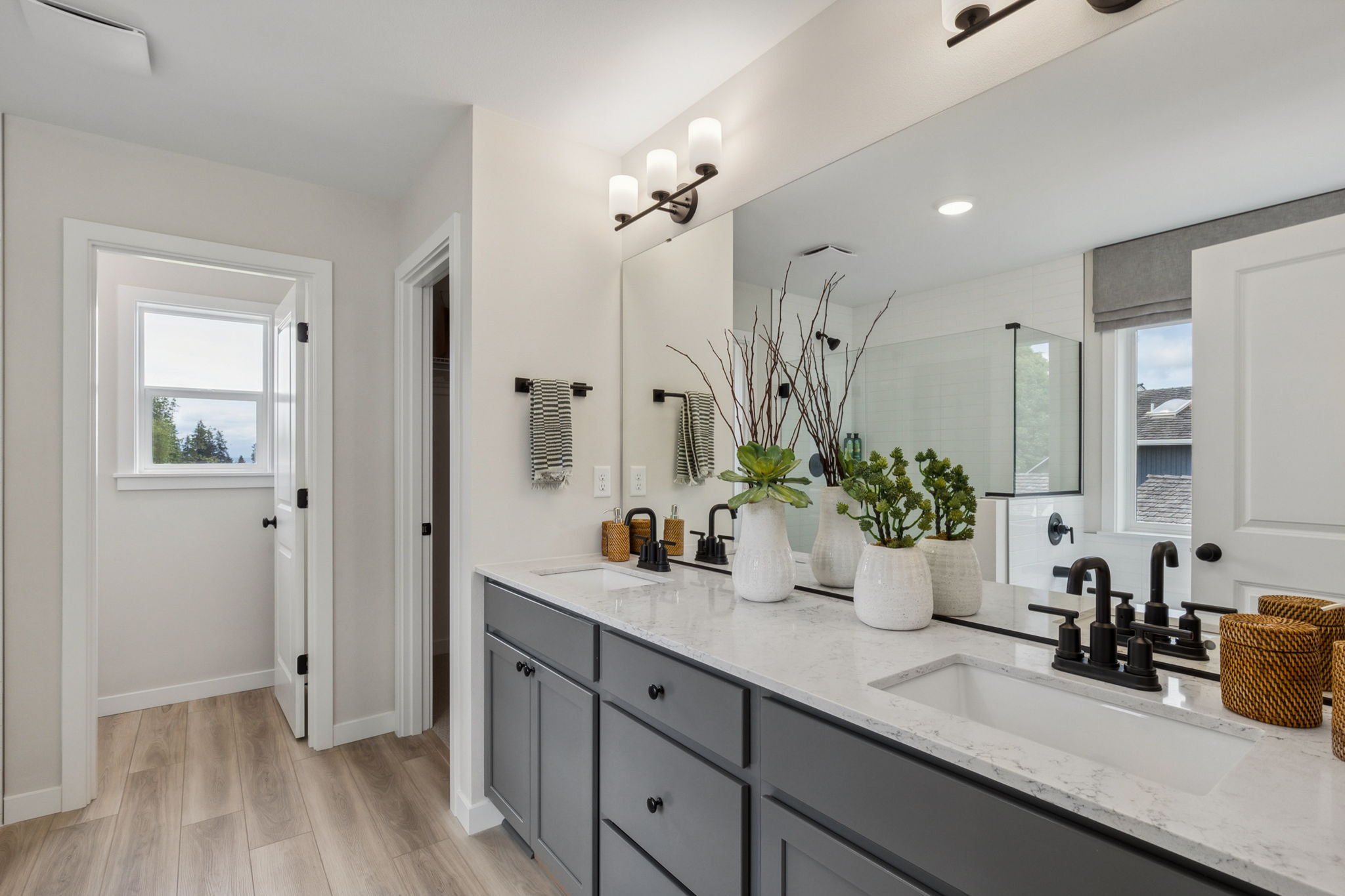 A bathroom with a large mirror.