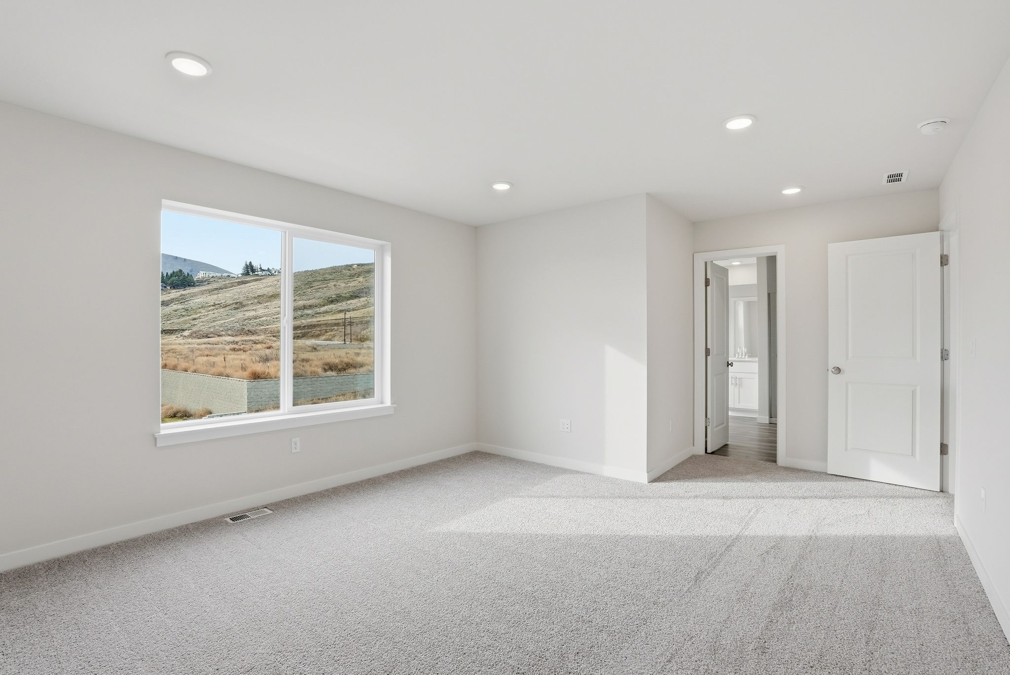 A room with a window and a door.