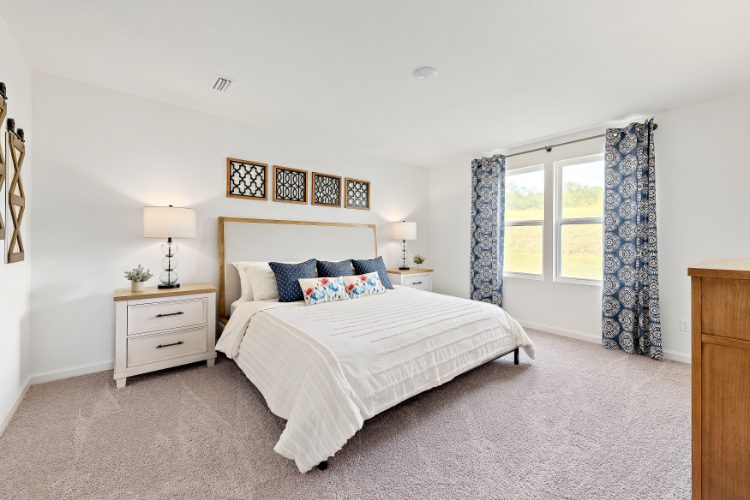 A bedroom with a bed and a window.