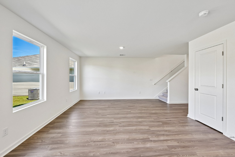 A room with white walls and a wood floor.