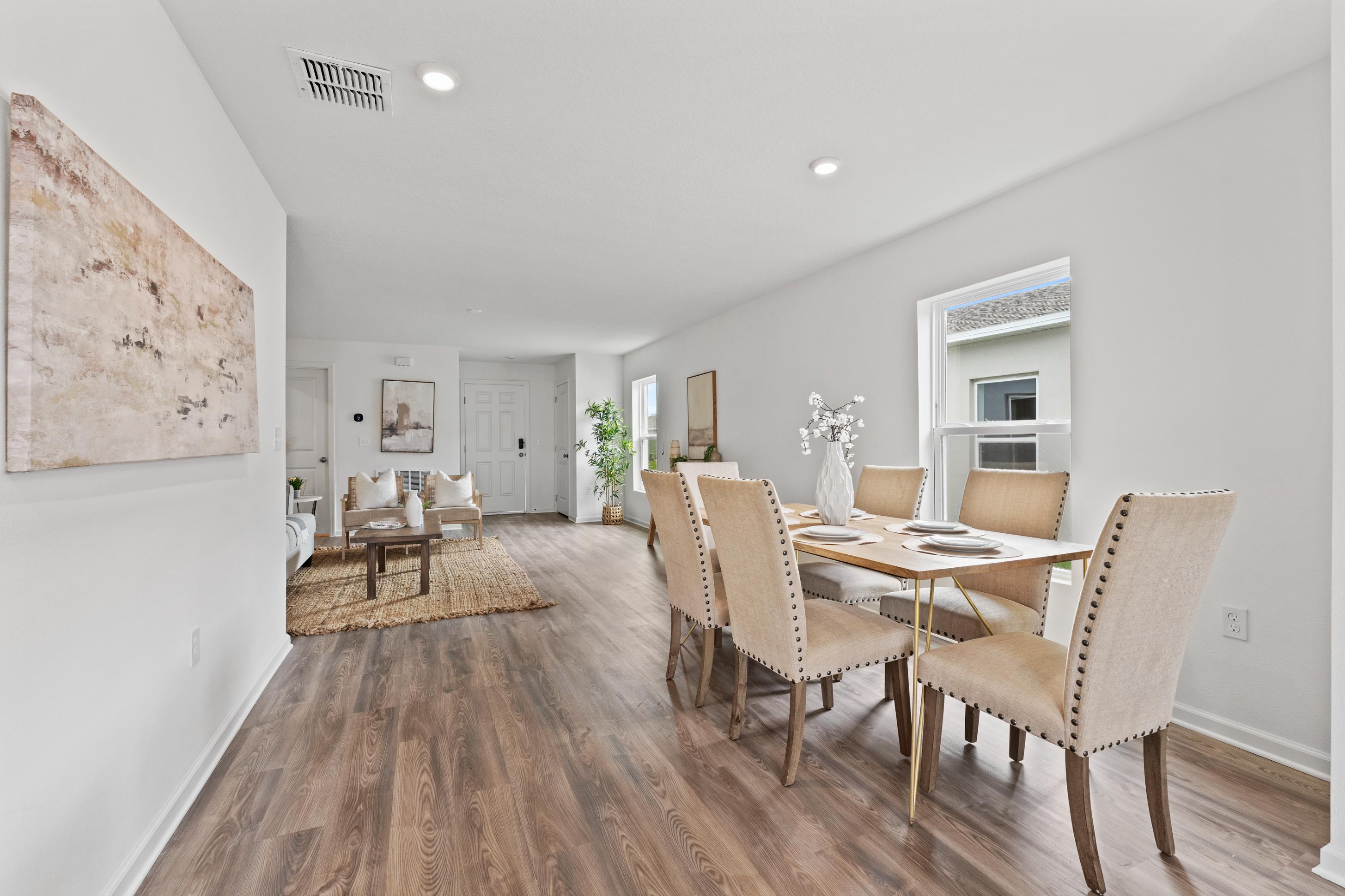 A dining room with a wood floor.
