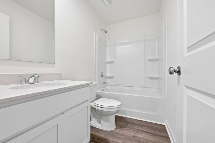 A bathroom with a toilet and sink.