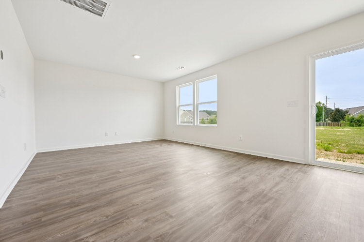 A room with a wood floor and a window.