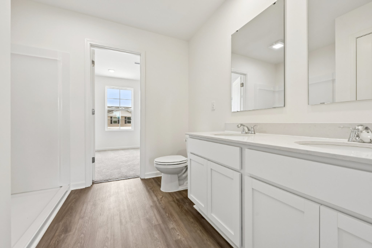 A bathroom with white cabinets.