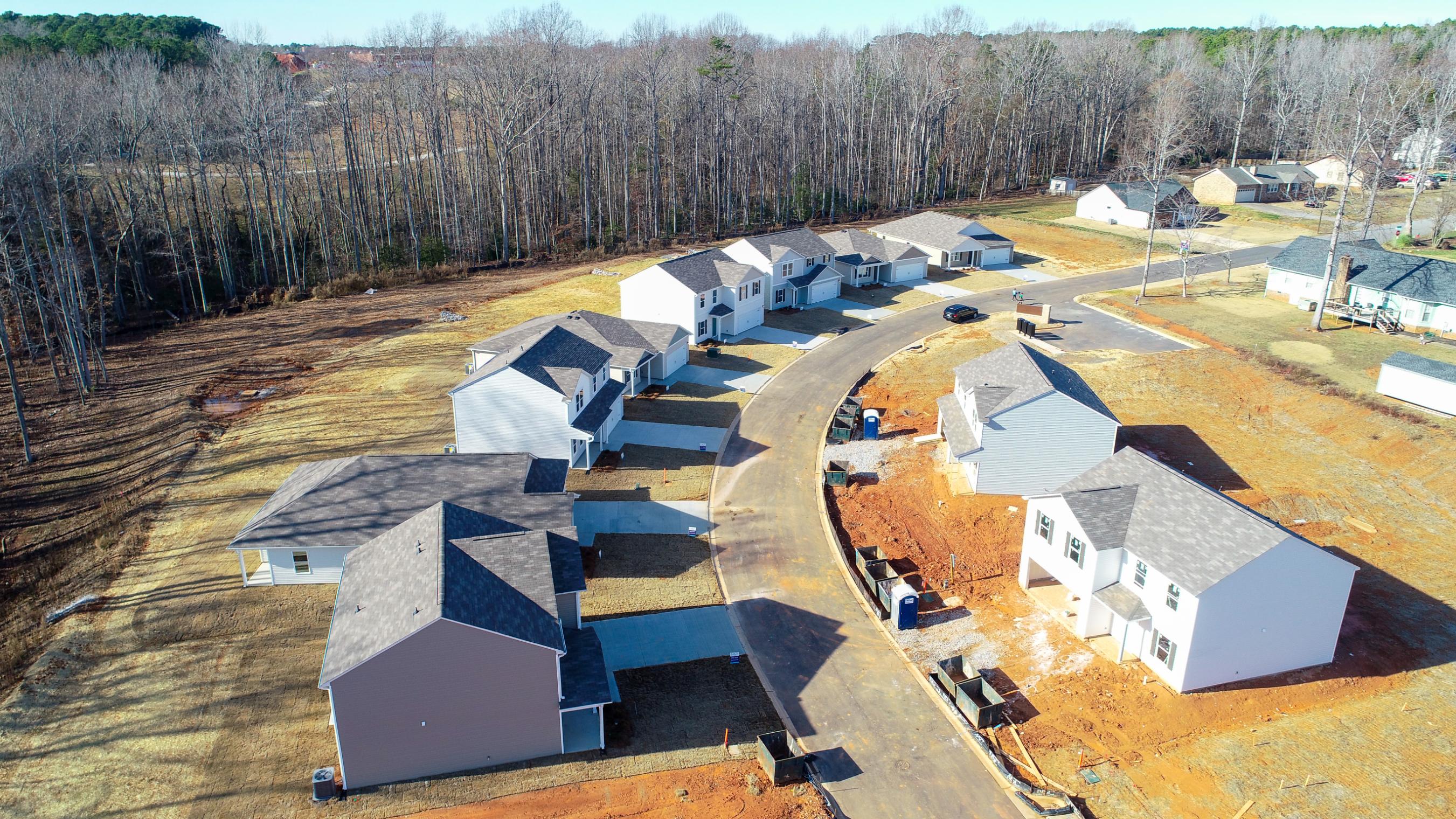 A group of houses with trees in the background.