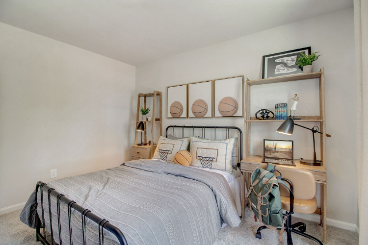 A bedroom with a bed and shelves.